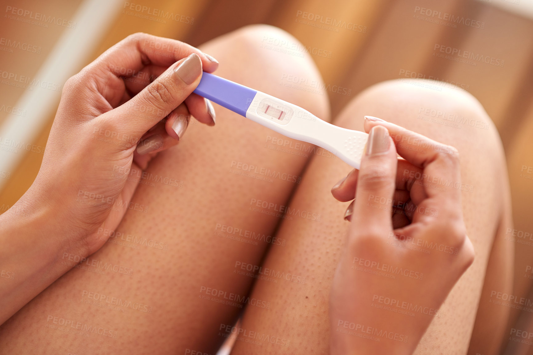 Buy stock photo Woman, hands and pregnancy test with positive results of line, stick or examination at home. Closeup of pregnant female person in motherhood with maternity exam for impregnation sign or expecting