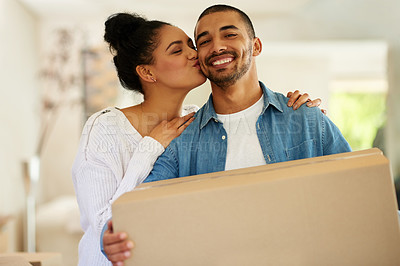 Buy stock photo Portrait of a happy young couple carrying cardboard boxes into their new home