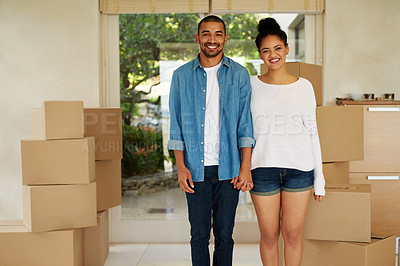 Buy stock photo Portrait of a happy young couple standing among cardboard boxes in their new home