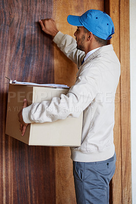 Buy stock photo Shot of a delivery man delivering a box to a customer's door