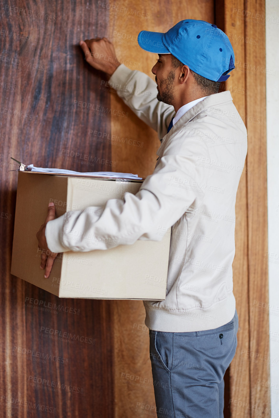 Buy stock photo Shot of a delivery man delivering a box to a customer's door