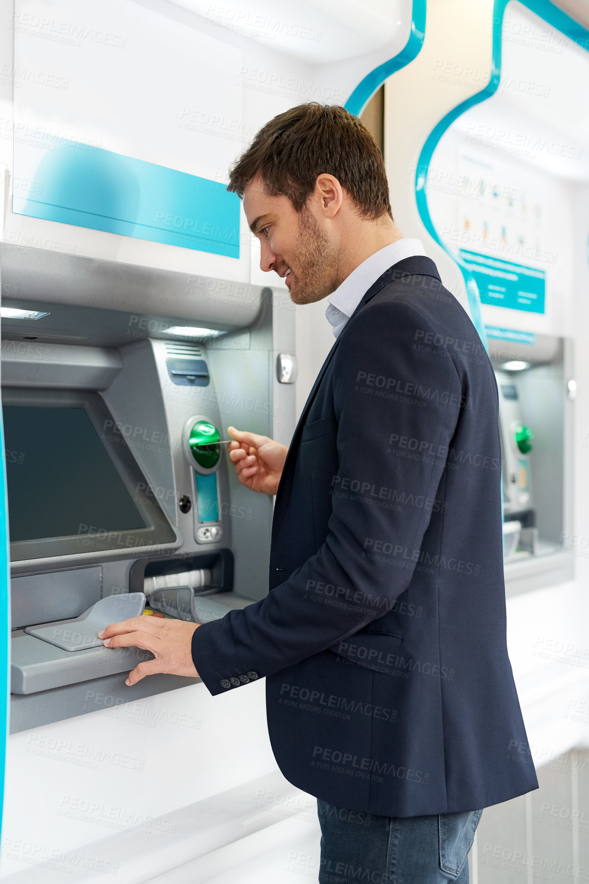 Buy stock photo Cropped shot of a young businessman making a transaction at an ATM