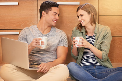 Buy stock photo Home, laptop and couple with cup, website and morning together for video streaming. Kitchen, floor and man with woman, relationship or romance with cappuccino and marriage with online entertainment