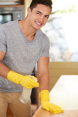 Buy stock photo Portrait of a happy young man cleaning his kitchen