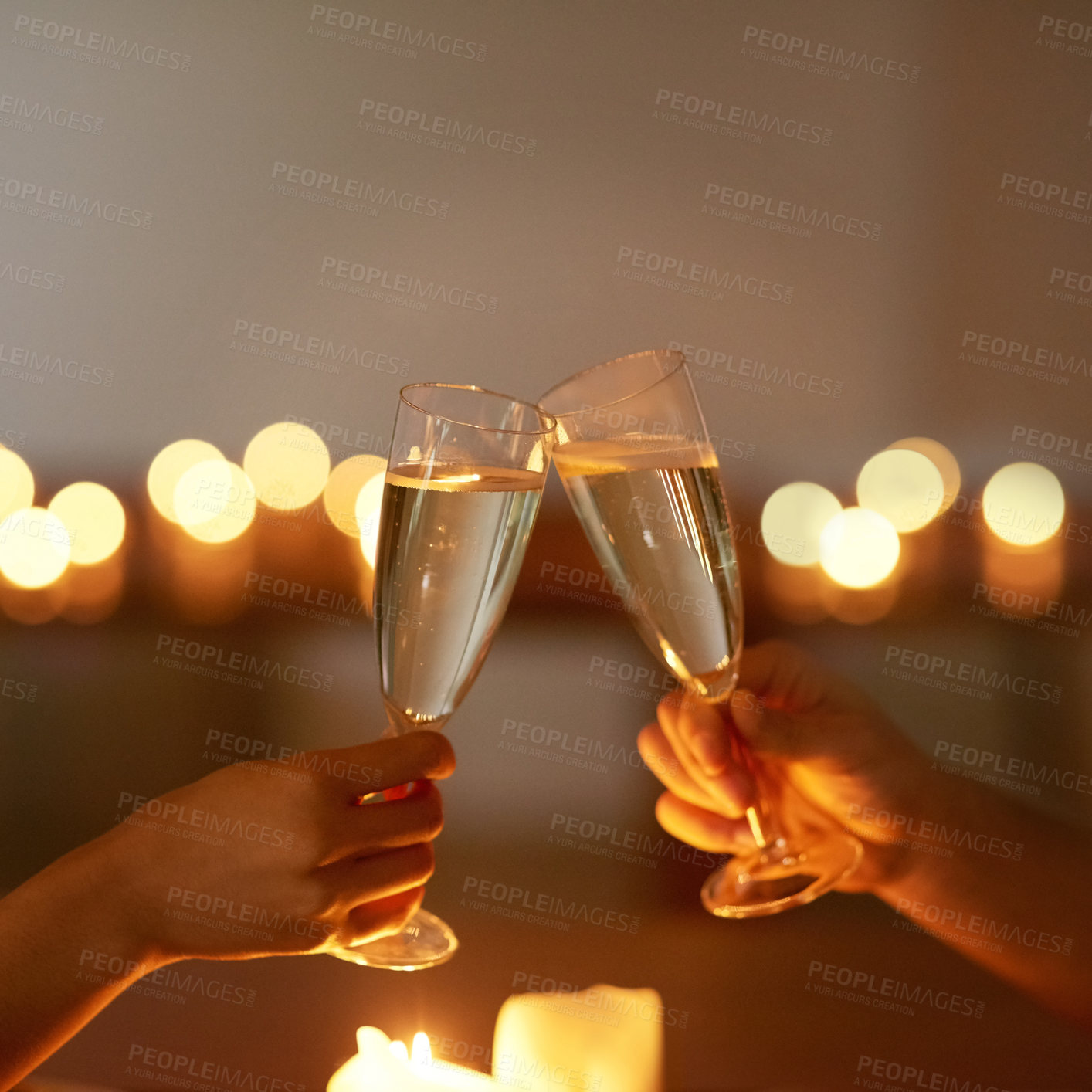 Buy stock photo Cropped shot of an unrecognizable couple toasting while on a date