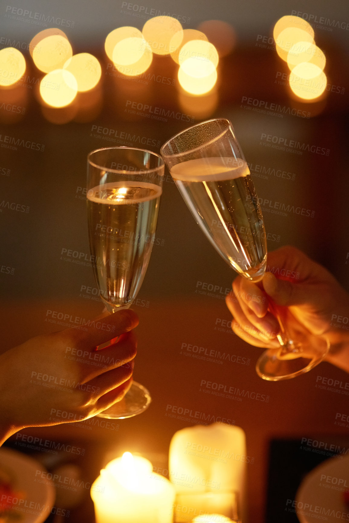 Buy stock photo Cropped shot of an unrecognizable couple toasting while on a date