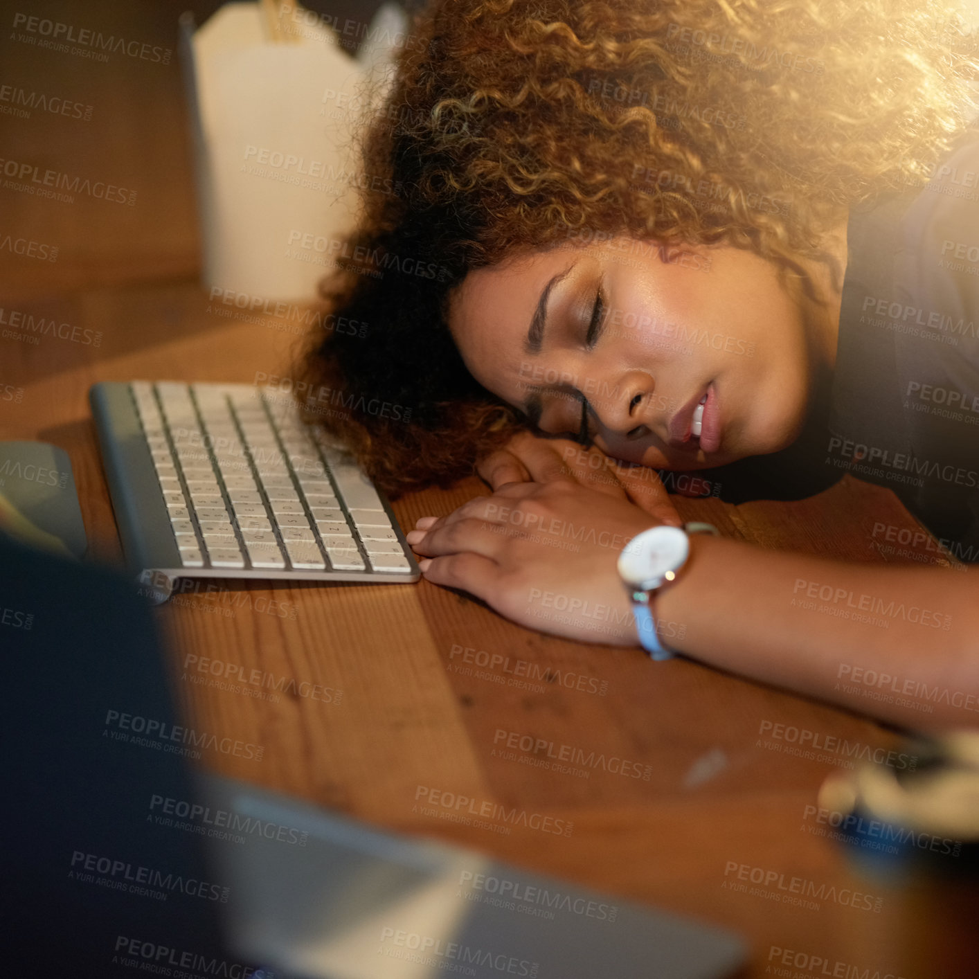 Buy stock photo Cropped shot of a young businesswoman sleeping on her desk while working late in an office