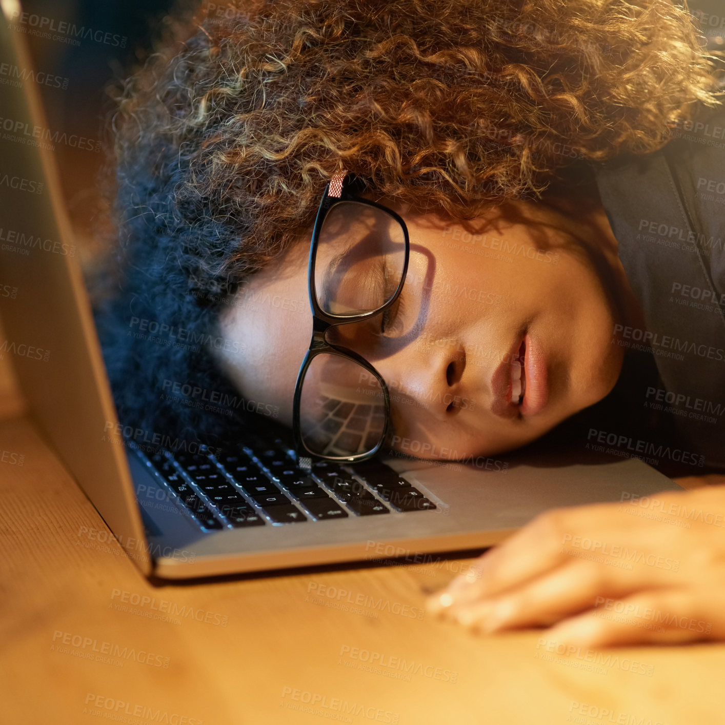 Buy stock photo Cropped shot of a young businesswoman sleeping on her laptop while working late in an office