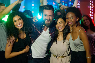 Buy stock photo Portrait of a group of smiling friends enjoying an eveing in a nightclub