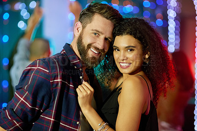 Buy stock photo Portrait of an affectionate young couple enjoying the evening in a nightclub