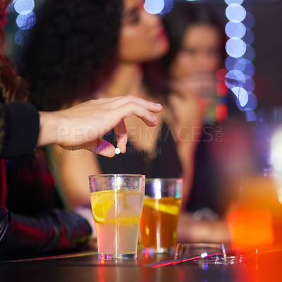 Buy stock photo Closeup shot of a man drugging a woman's drink in a nightclub