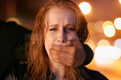 Buy stock photo Portrait of a frightened young woman being grabbed by a criminal in the city