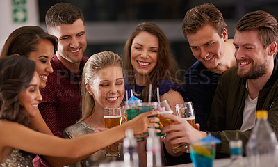Buy stock photo Shot of a happy group of friends having drinks at a bar together