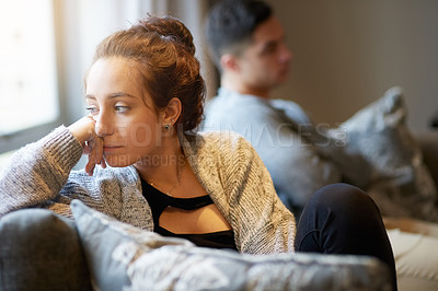 Buy stock photo Shot of a young woman looking despondent after a fight with her boyfriend