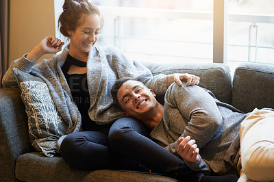 Buy stock photo Portrait of a handsome young man lying on his girlfriend's lap on the sofa