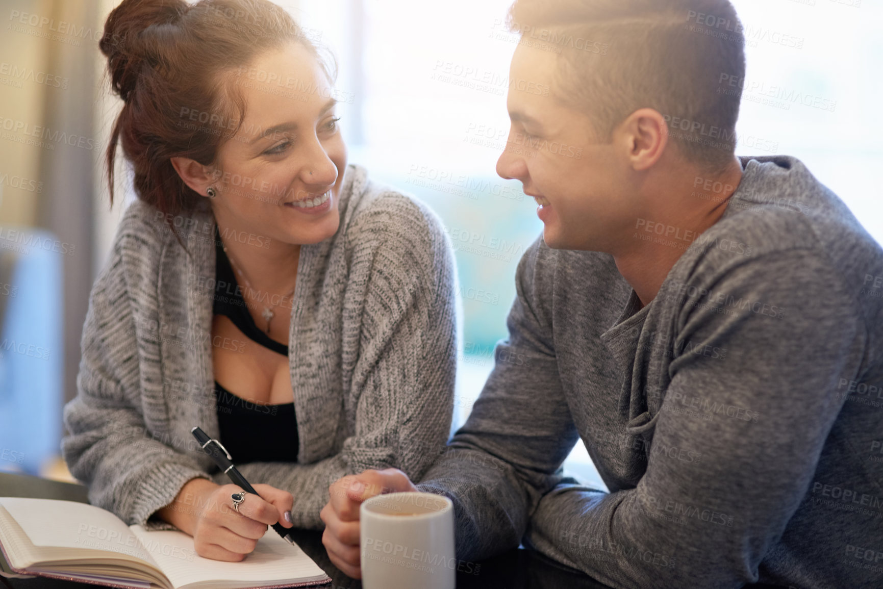 Buy stock photo Shot of a happy young couple relaxing at home