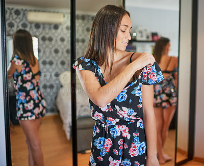 Buy stock photo Shot of an attractive young woman getting dressed in the morning