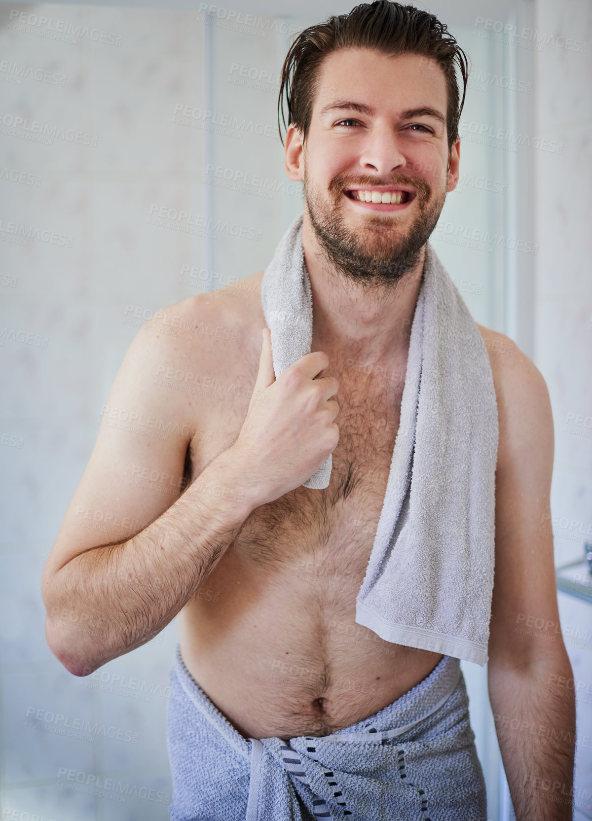 Buy stock photo Cropped shot of a handsome young man wrapped in a towel after a shower