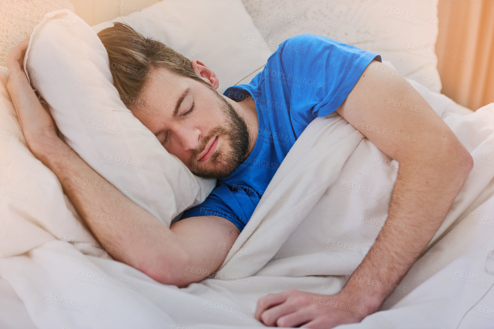 Buy stock photo Cropped shot of a handsome young man sleeping in bed at home