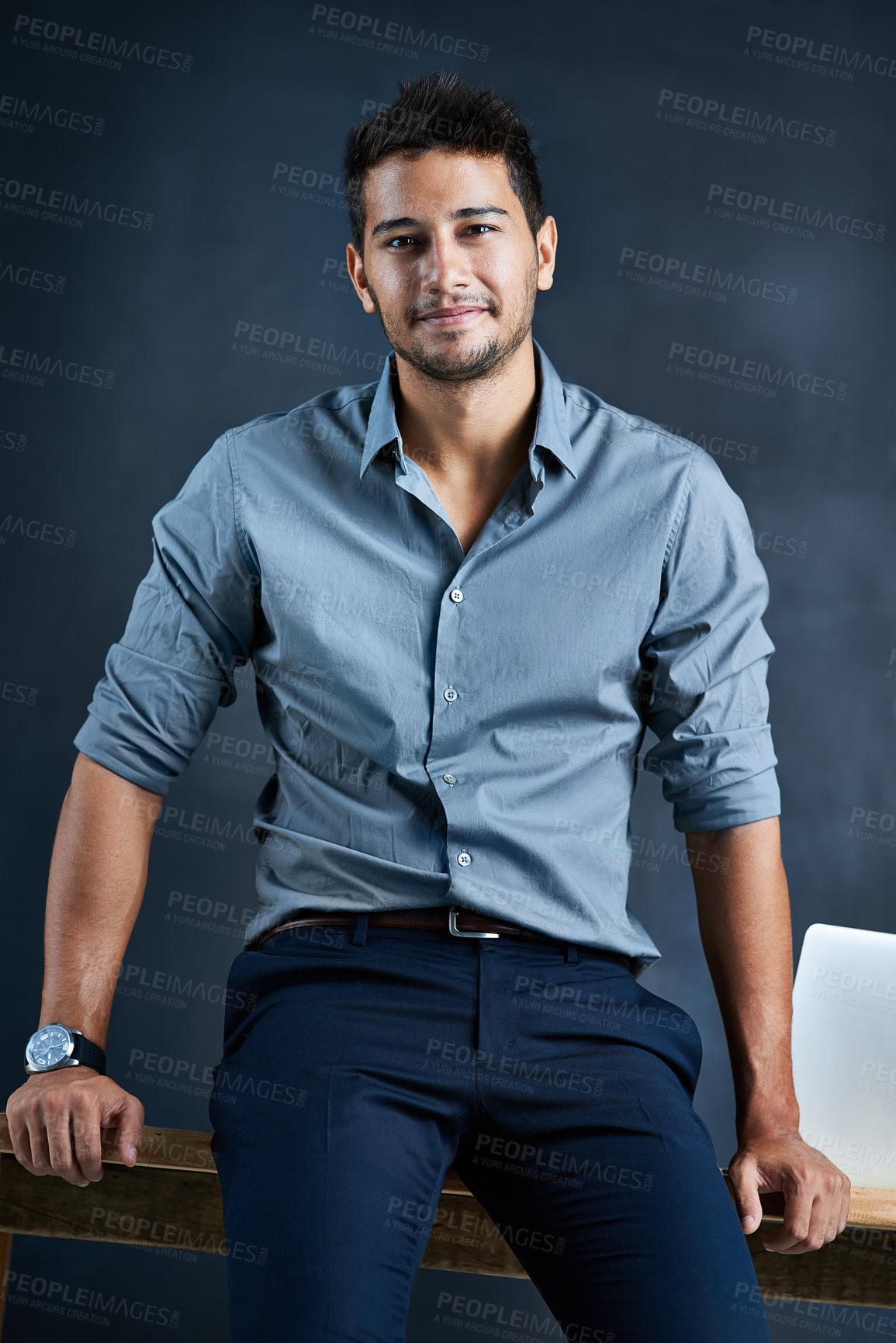 Buy stock photo Portrait of a handsome young businessman standing  against a dark background