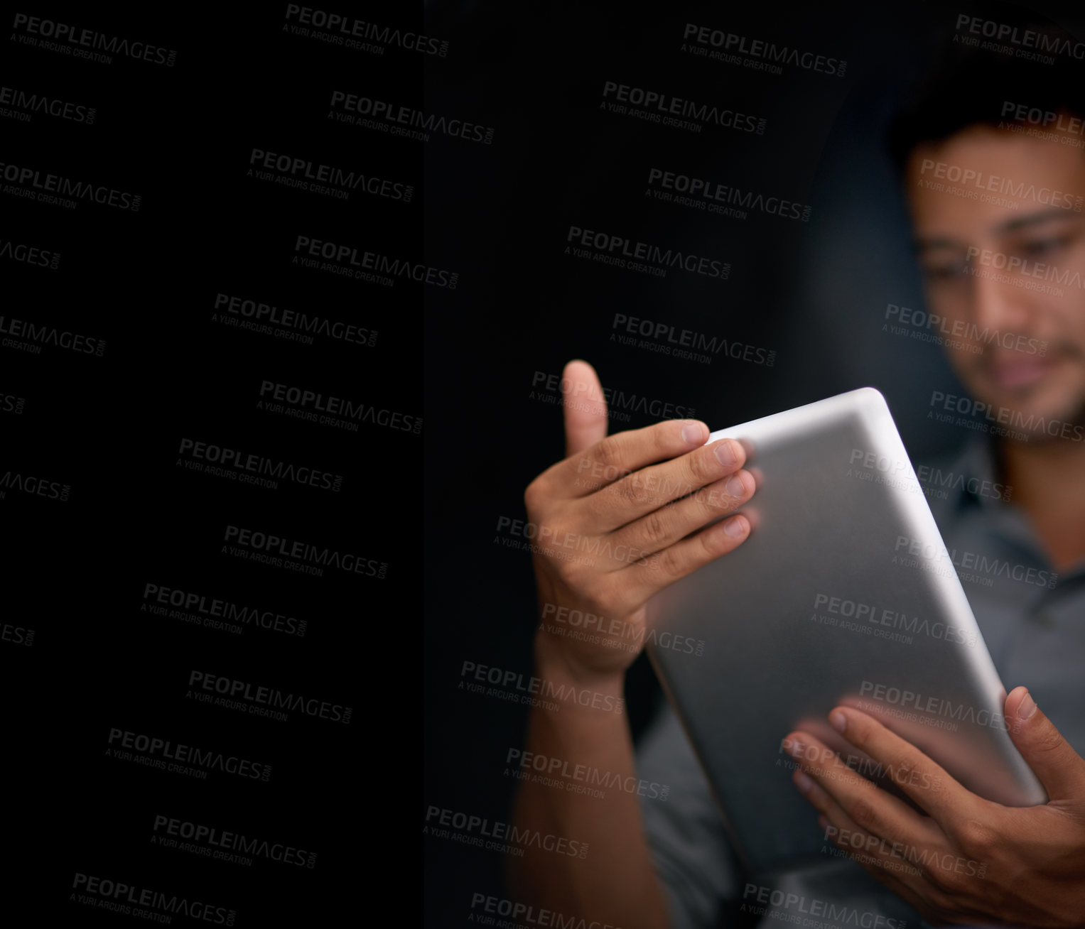 Buy stock photo Cropped shot of a young man using his tablet at night