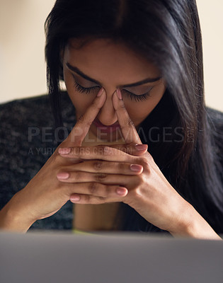 Buy stock photo Shot of an attractive young woman looking sressed while surfing the net at home