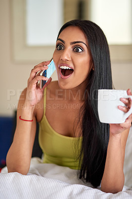 Buy stock photo Shot of a young woman talking on the phone in bed and looking surprised