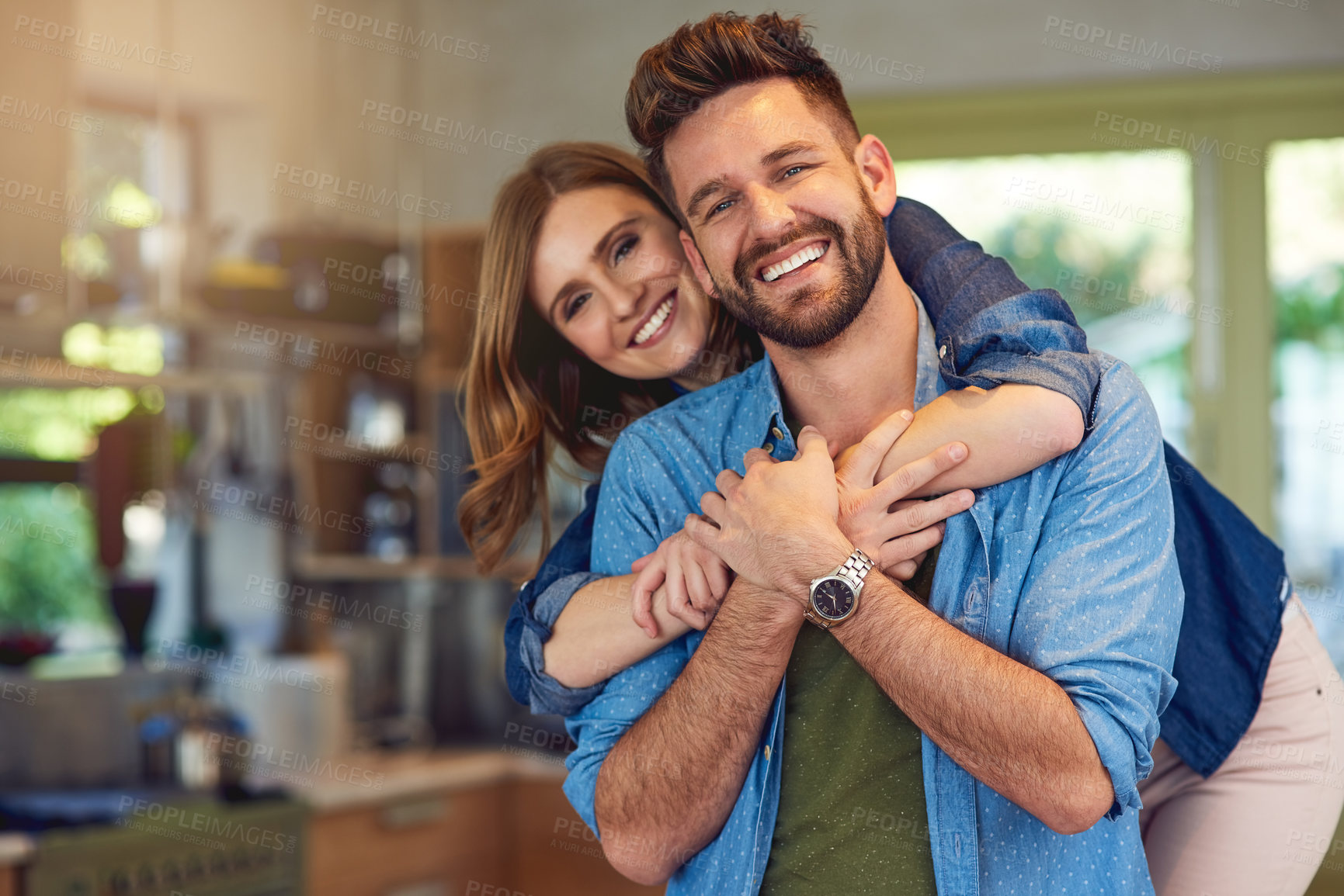 Buy stock photo Portrait of a happy young couple embracing at home