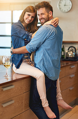 Buy stock photo Shot of an affectionate young couple sharing a romantic moment in the kitchen at home