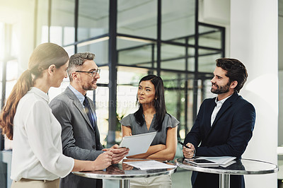 Buy stock photo Shot of a group of colleagues discussing business in the office