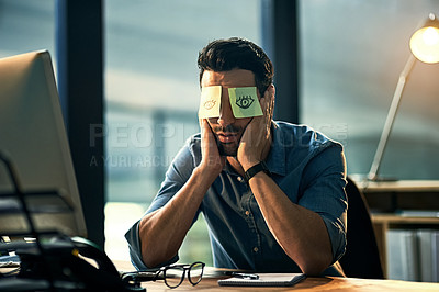 Buy stock photo Shot of a tired young businessman working late in an office with adhesive notes covering his eyes