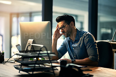 Buy stock photo Business man with a stress headache feeling tired, pain and stressed while working on a computer. Young male office worker work on a deadline late at night. IT technology guy looking upset