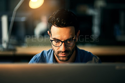 Buy stock photo IT guy working with computer late at night, searching online while planning, thinking strategy or typing out deadline. Business man with glasses looking serious and concentrating in office