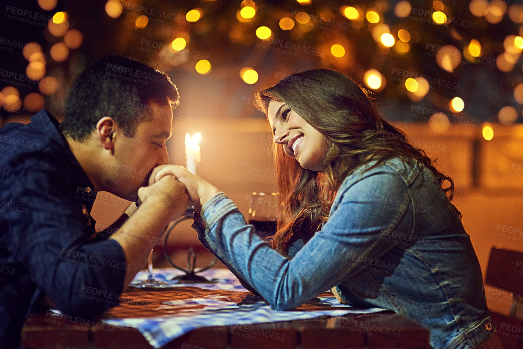 Buy stock photo Date, hand kiss and excited woman in couple at restaurant for marriage and celebration with love. Candle, dinner and romance with proposal with happy people at night at table with smile and bokeh