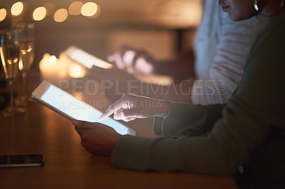 Buy stock photo Cropped shot of a woman using a digital tablet at night