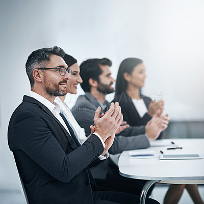 Buy stock photo Shot of a group of businesspeople applauding during a meeting in the boardroom