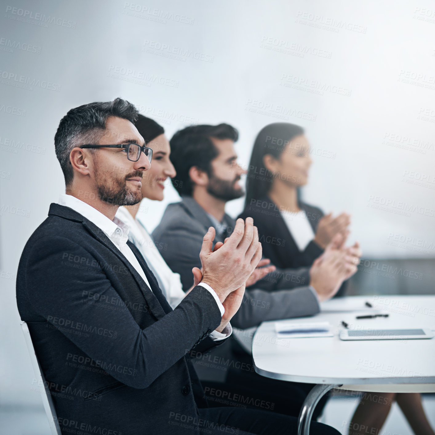 Buy stock photo Shot of a group of businesspeople applauding during a meeting in the boardroom