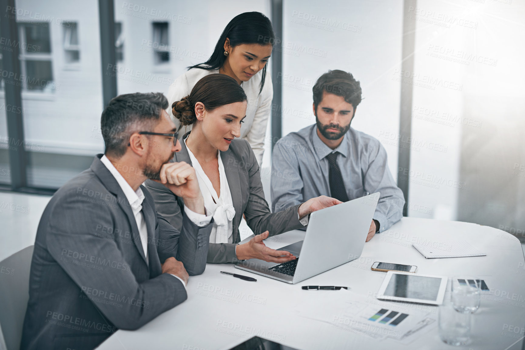 Buy stock photo Shot of a group of businesspeople meeting in the boardroom