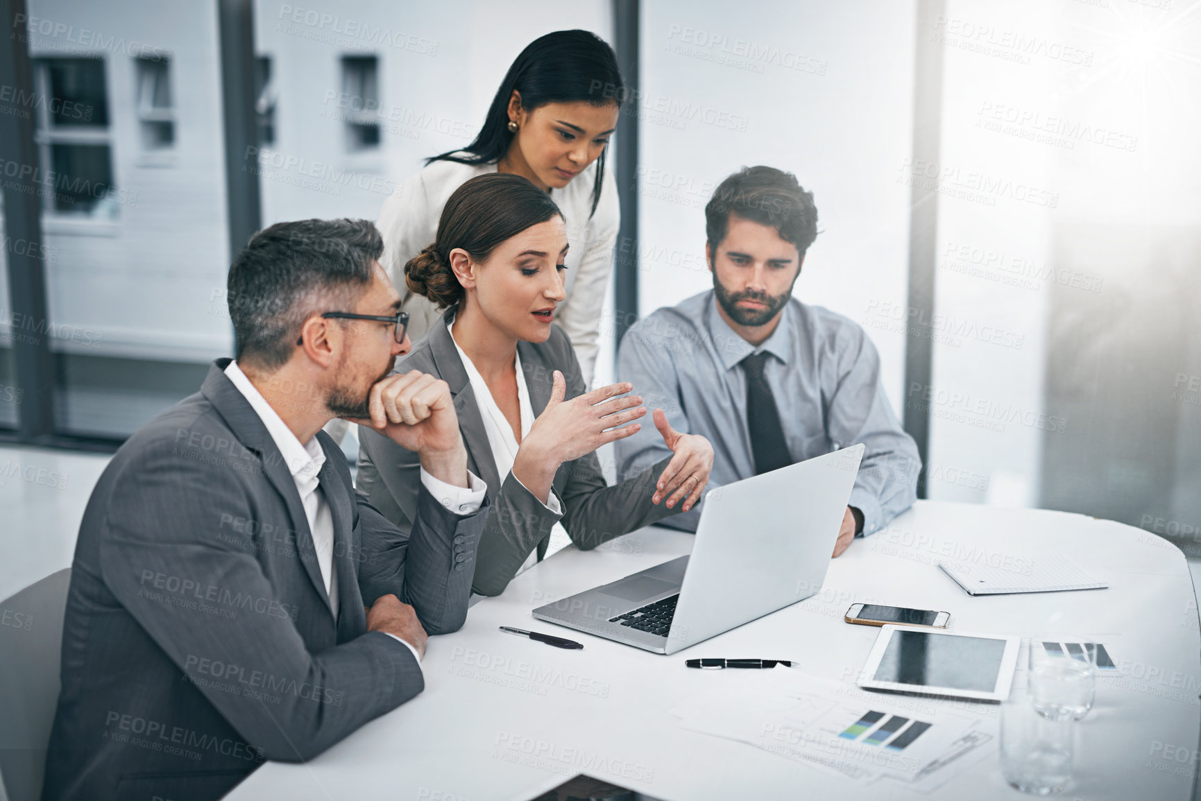 Buy stock photo Shot of a group of businesspeople meeting in the boardroom