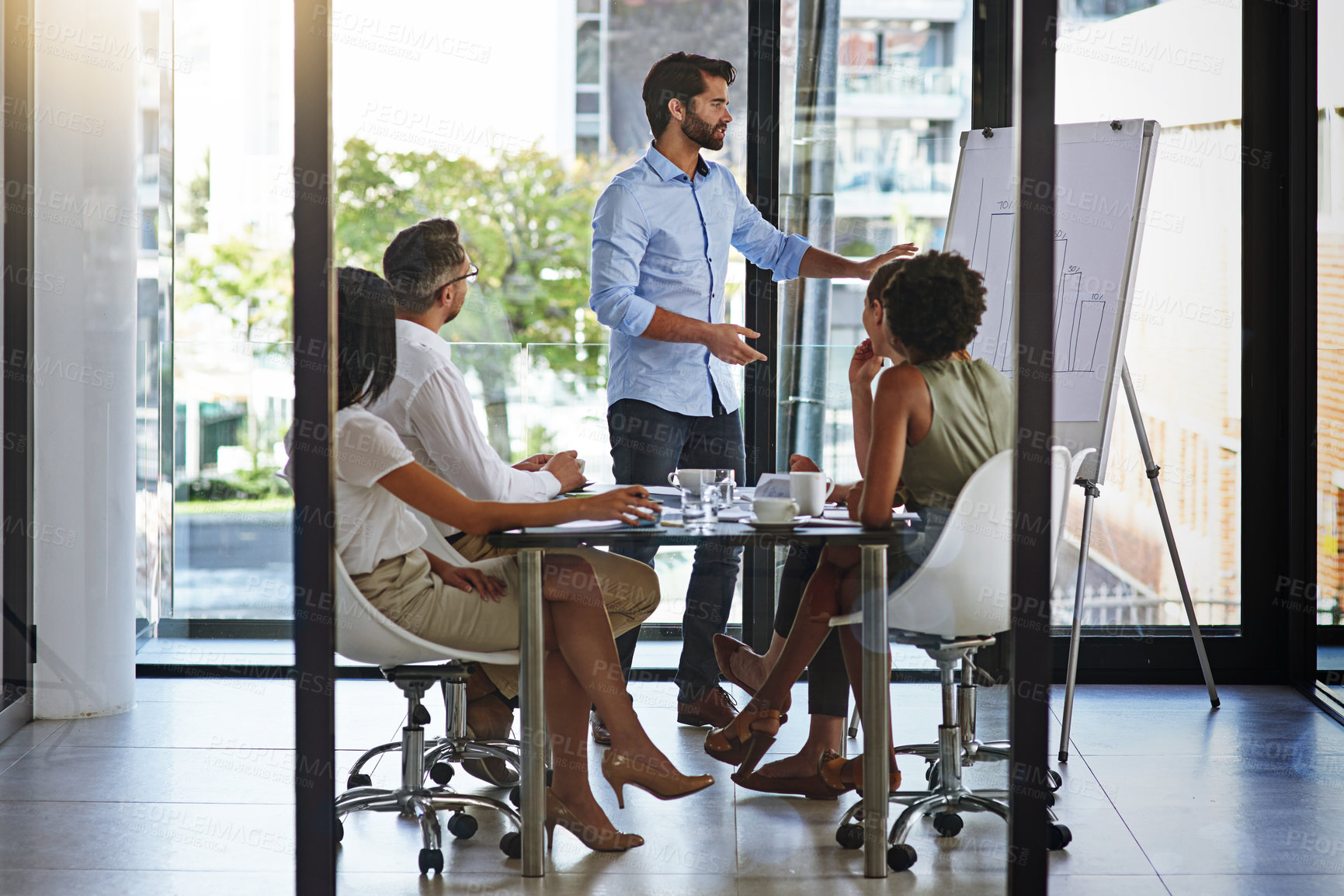 Buy stock photo Shot of a group of man giving a whiteboard presentation to colleagues in a boardroom