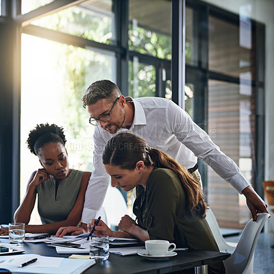 Buy stock photo Shot of a group of businesspeople having a meeting in a boardroom