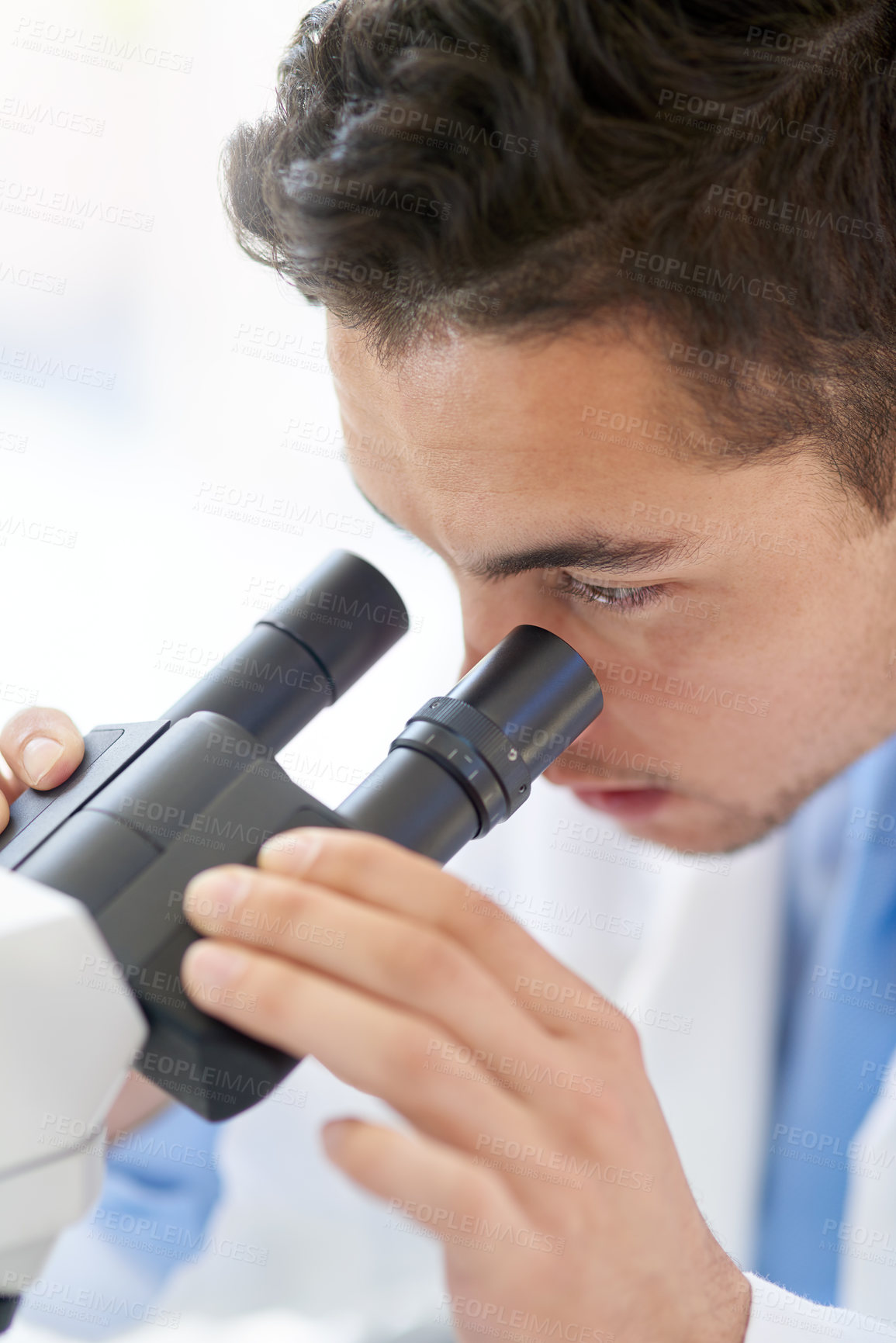 Buy stock photo Cropped shot of a young male scientist working in his lab