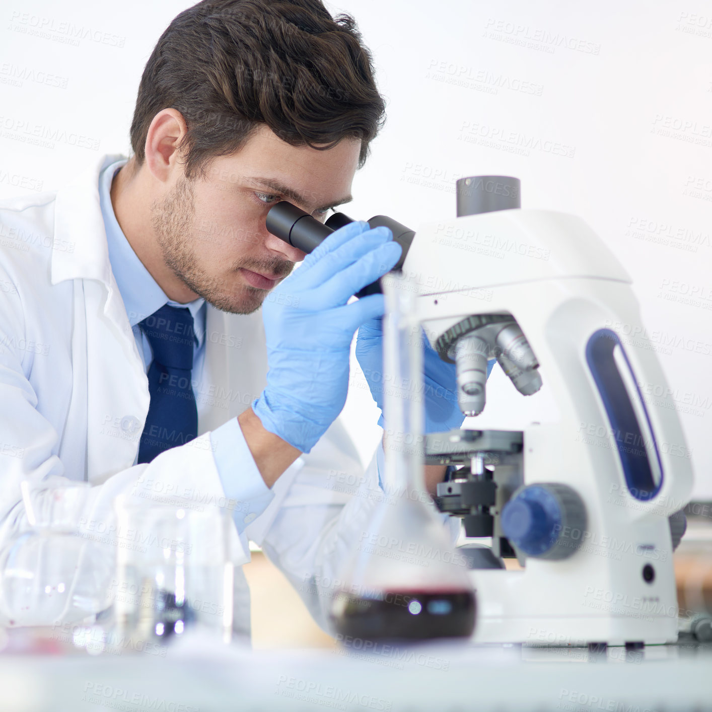 Buy stock photo Science, exam and man with microscope in lab for vaccine study, dna test or medical experiment. Scientist, research and investigation with biotechnology for stem cell, innovation and development