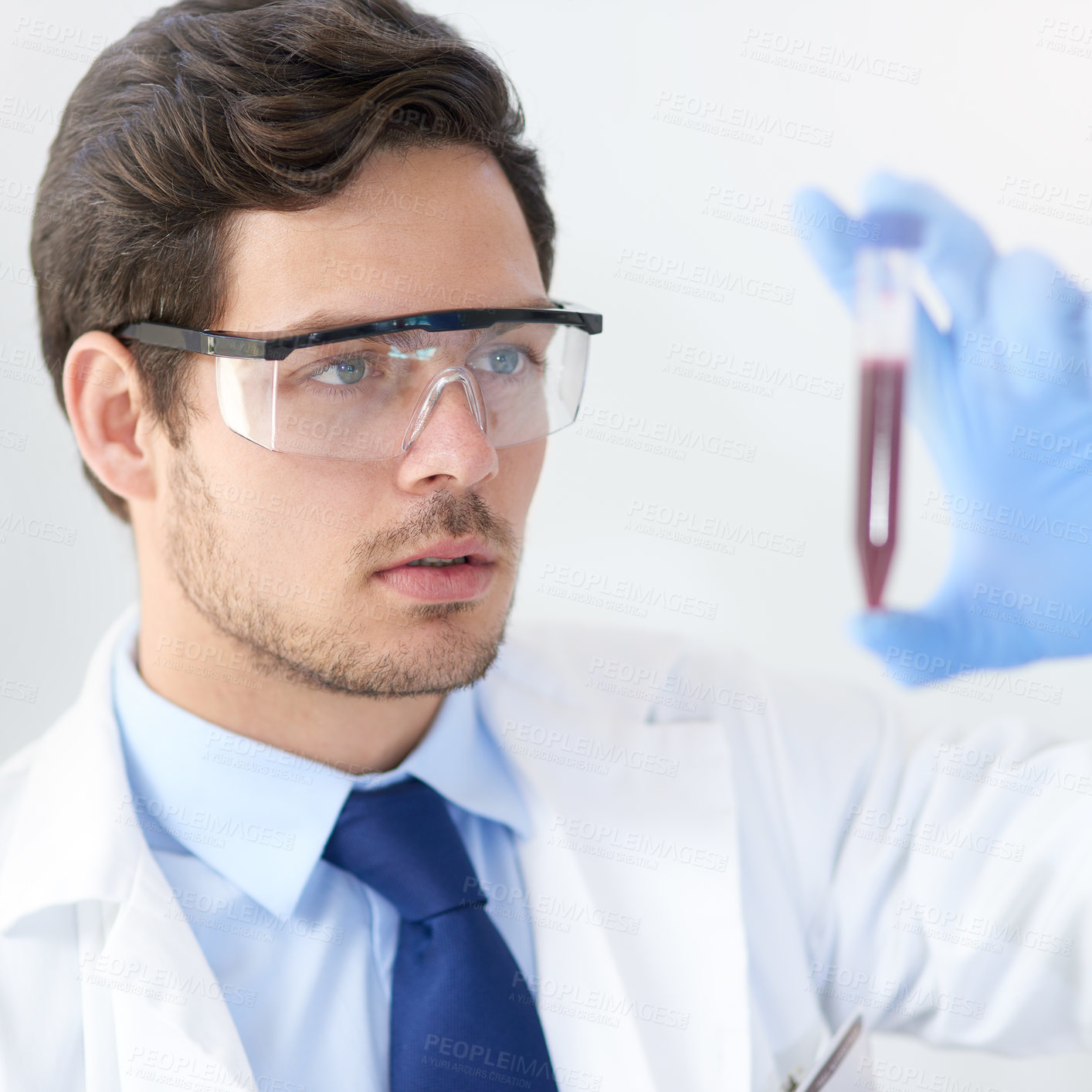 Buy stock photo Cropped shot of a young male scientist working in his lab