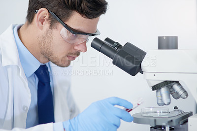 Buy stock photo Cropped shot of a young male scientist working in his lab