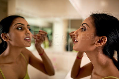 Buy stock photo Cropped shot of a young woman applying mascara in the bathroom