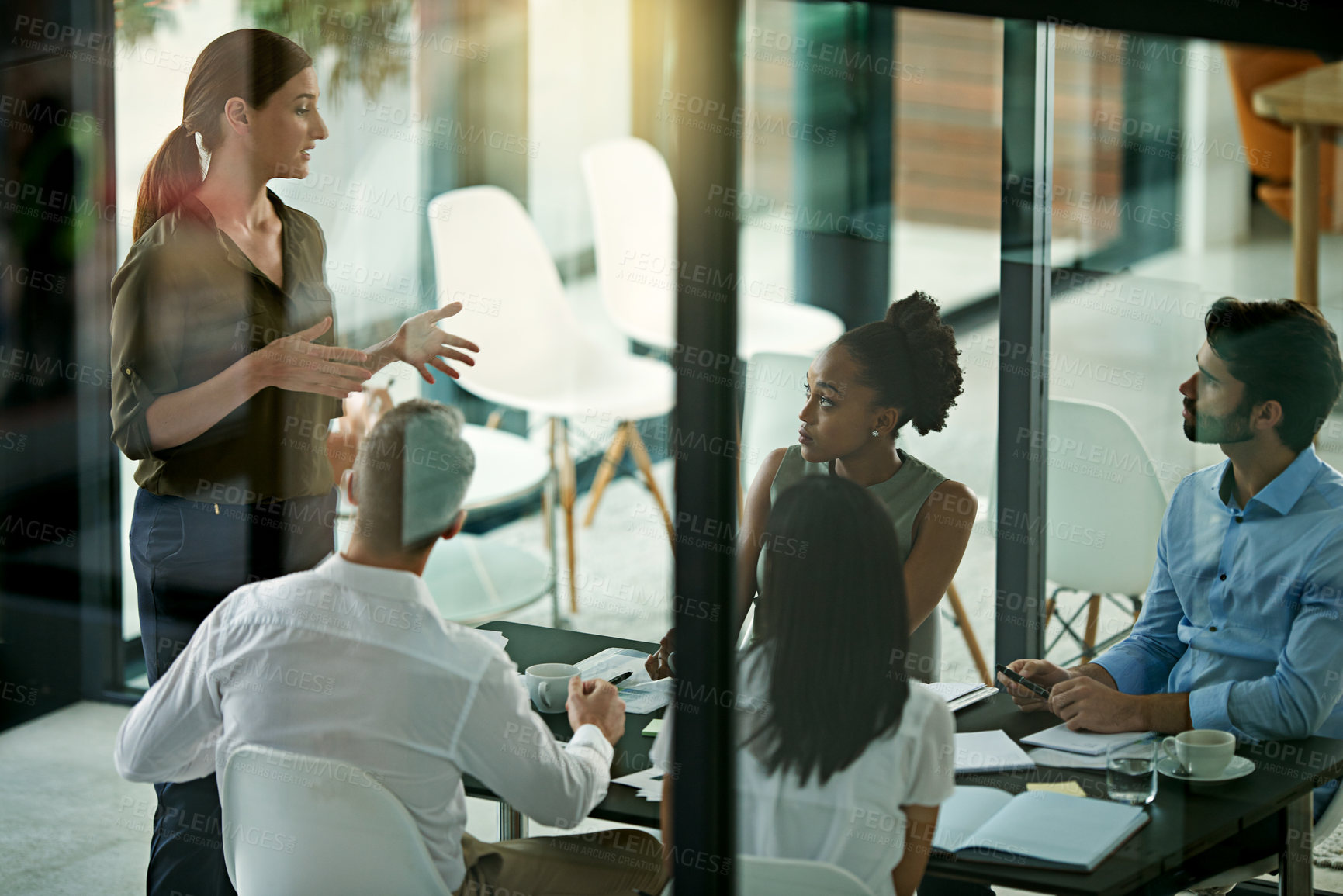 Buy stock photo High angle shot of a young businesswoman giving a presentation in the boardroom