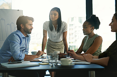 Buy stock photo Shot of a group of businesspeople meeting in the boardroom