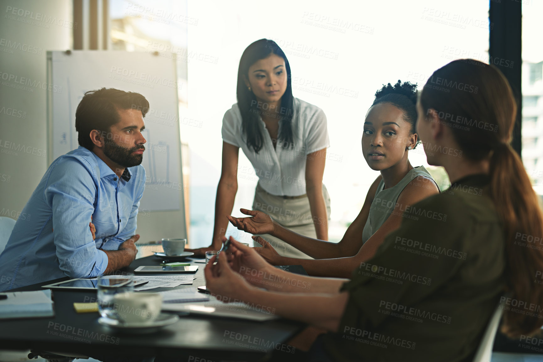 Buy stock photo Shot of a group of businesspeople meeting in the boardroom