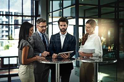Buy stock photo Shot of a group of businesspeople meeting in the office